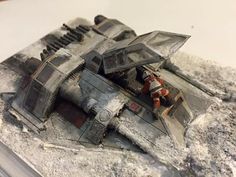 a toy model of a space ship sitting on top of a book with dust around it