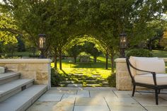 an outdoor sitting area with stone steps and benches