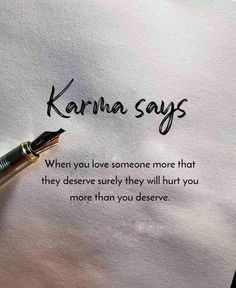 a fountain pen sitting on top of a piece of paper with the words karma says