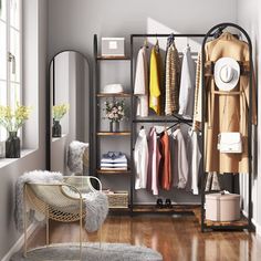 an organized closet with clothes, shoes and other items on shelves in front of a window