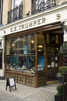 the storefront of a jewelry store on a city street in europe, with an open window