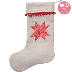 a white christmas stocking with red pom poms