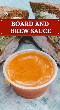 a sandwich cut in half sitting on top of a table next to a bowl of soup