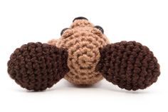 a crocheted stuffed animal laying on top of it's back with its eyes closed