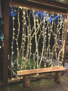 a wooden bench sitting next to a window covered in lights