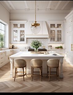 a kitchen with white cabinets and wooden floors, two stools at the center island