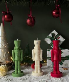 small candles are sitting on a table with christmas decorations