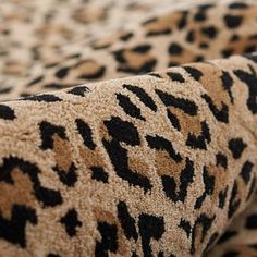 the leopard print fabric has black spots on it's back and tan, brown, and black colors