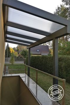 an outdoor covered patio area with metal railings