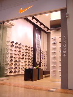 the inside of a shoe store with lots of shoes on display