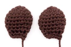 two brown crocheted hats are shown on a white background