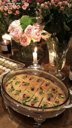 a table topped with lots of food and candles