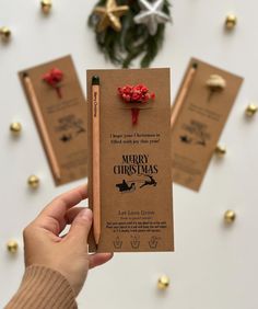 a person holding up a christmas card with candy on it