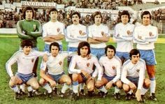 a group of men standing next to each other on a soccer field