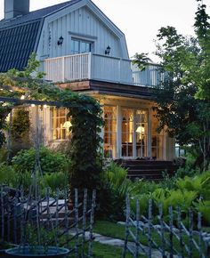 the house is lit up at night in the garden