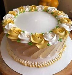 a cake decorated with yellow and white flowers