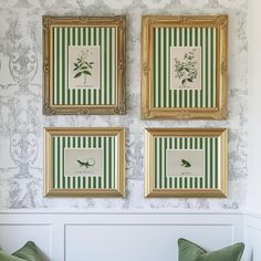 three framed pictures hang on the wall above two green and white pillows, along with matching throw pillows