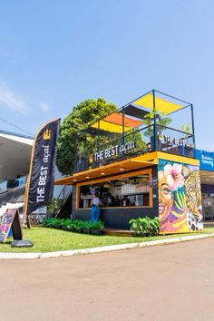 an outside view of a restaurant that is painted yellow and blue with the words the best coffee on it