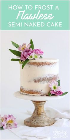 a white cake with pink flowers on top and the words how to frost a habless