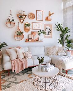 a living room filled with furniture and lots of pictures on the wall above it's coffee table