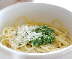 a white bowl filled with pasta and broccoli