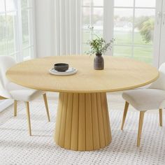 a round table with white chairs and a plant in the center on top of it