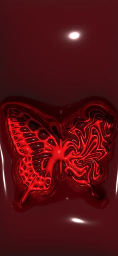 a red butterfly shaped object on a dark background