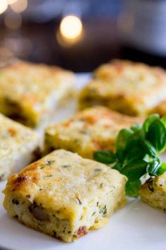 some food is on a white plate with green garnish and parmesan cheese