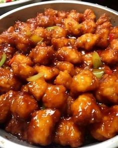 a bowl filled with meat and sauce on top of a table