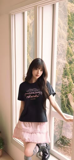 a young woman posing in front of a window with her leg up on the windowsill