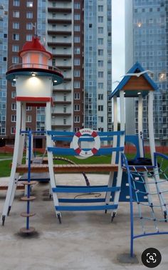 an empty playground in front of some tall buildings