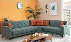 a living room filled with furniture and orange walls