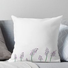 a white pillow with purple flowers on it