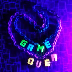 the word game over spelled in neon letters on a purple and blue background with chains