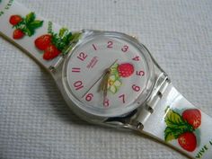 a white watch with strawberries on it