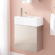 a white sink sitting under a mirror next to a wall mounted faucet in a bathroom