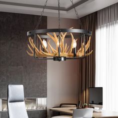 a chandelier hanging over a dining room table with chairs and a laptop on it