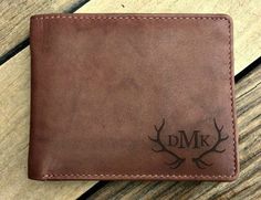 the personalized leather wallet is sitting on a wooden surface