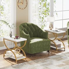 a living room with green chairs and a clock on the wall