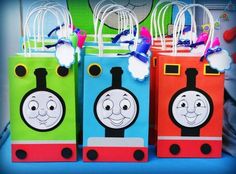 thomas the tank engine birthday party treat bags with tags on each bag and some decorations