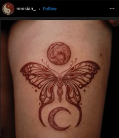 a woman's thigh with a butterfly and moon tattoo on the side of her leg