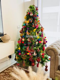 a colorful christmas tree in the corner of a living room