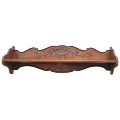 a wooden shelf with carvings on it