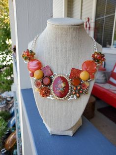 "My Momma and I made this statement bib necklace using broken pieces of new and old pieces of jewelry!  It's perfect for any special occasion or to wear any day!  Handmade repurposed necklace silver tone metal statement bib necklace. Made with broken & newer pieces of jewelry, brooches, pins earrings, and lobster clasp.   It has a cameo with roses **If you live outside the USA message me and I'll give you a shipping quote.** *Look us up on Facebook at:  \"Sparkle my Glitter\" to see more of our Pins Earrings, Repurposed Necklace, Flowers Orange, Broken Pieces, Statement Bib Necklace, Bib Necklaces, Necklace Unique, Bib Necklace, Unique Necklaces