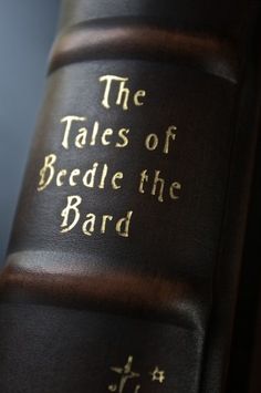 the tales of beddle the bard written on an old leather book with gold lettering