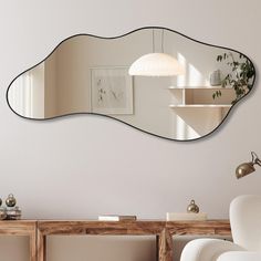 an oval shaped mirror hanging on the wall