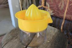 a yellow cup sitting on top of a wooden table