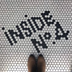 a person standing in front of a tiled floor