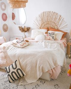 a white bed with pink and gold decor