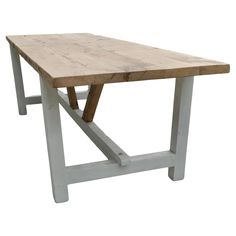 a wooden table sitting on top of a white floor